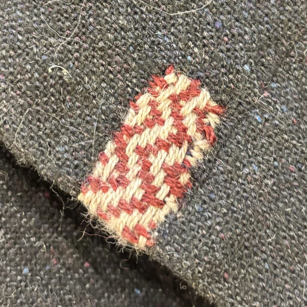 A chevron twill patch in greige and maroon